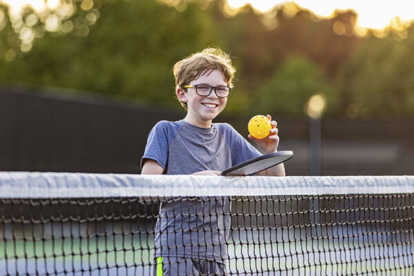 A boy playing Pickleball